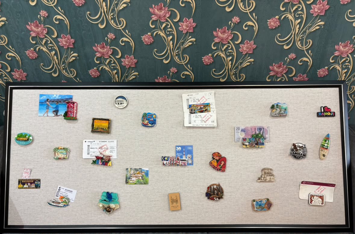 Magnetic board holding boarding passes, airline flight tickets, and beach vacation magnets