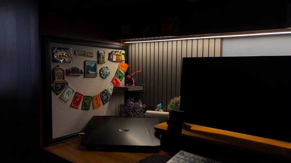 Illuminated desk study setup with magnetic travel souvenir board and Himalayan prayer flags